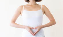 お腹でハートマークを作る女性